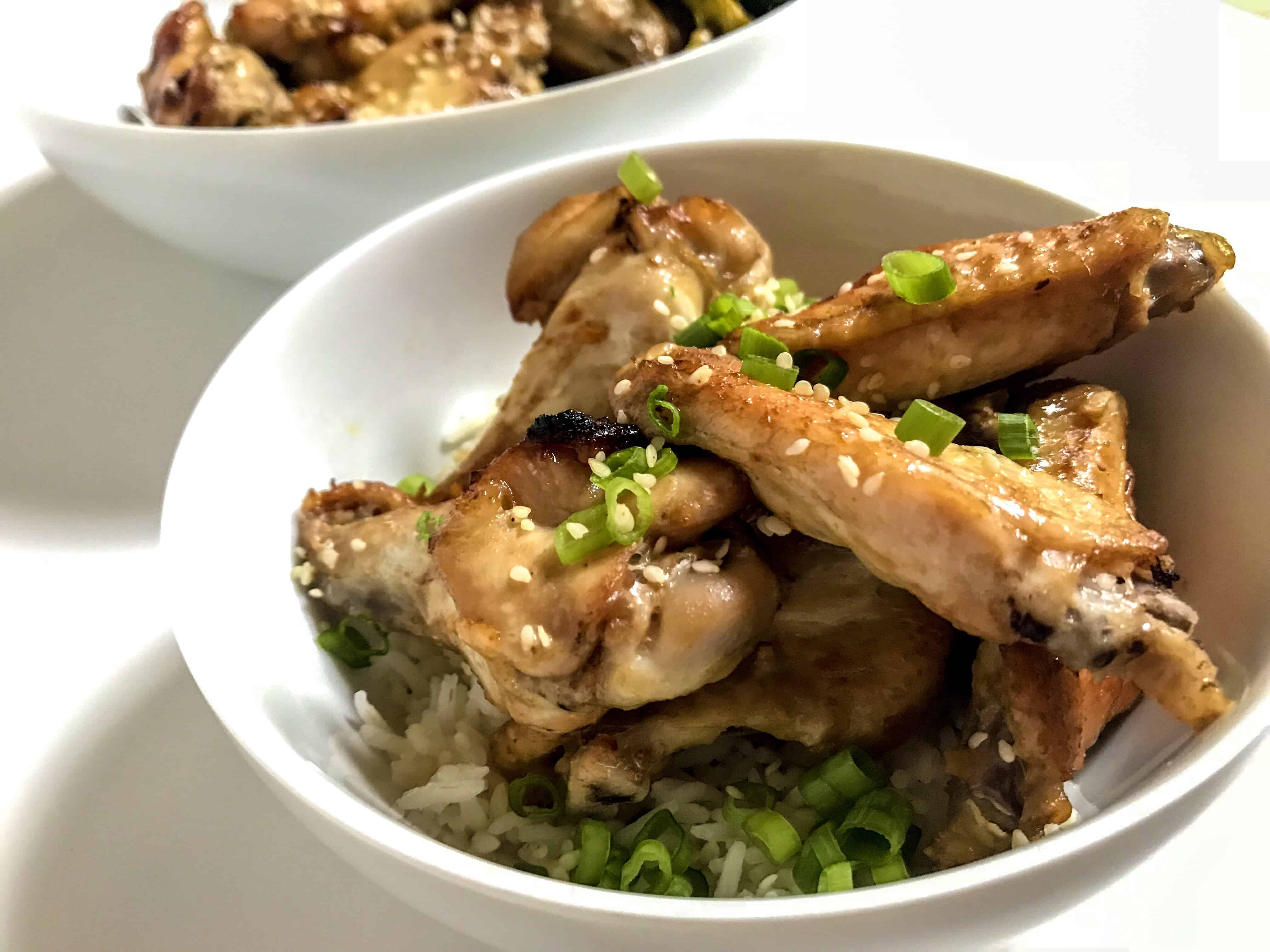 sticky sesame wings with scallions to garnish