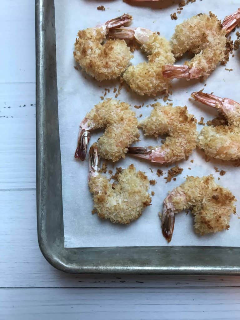 aerial view of shrimp sitting on top of parchment paper after coming out of oven