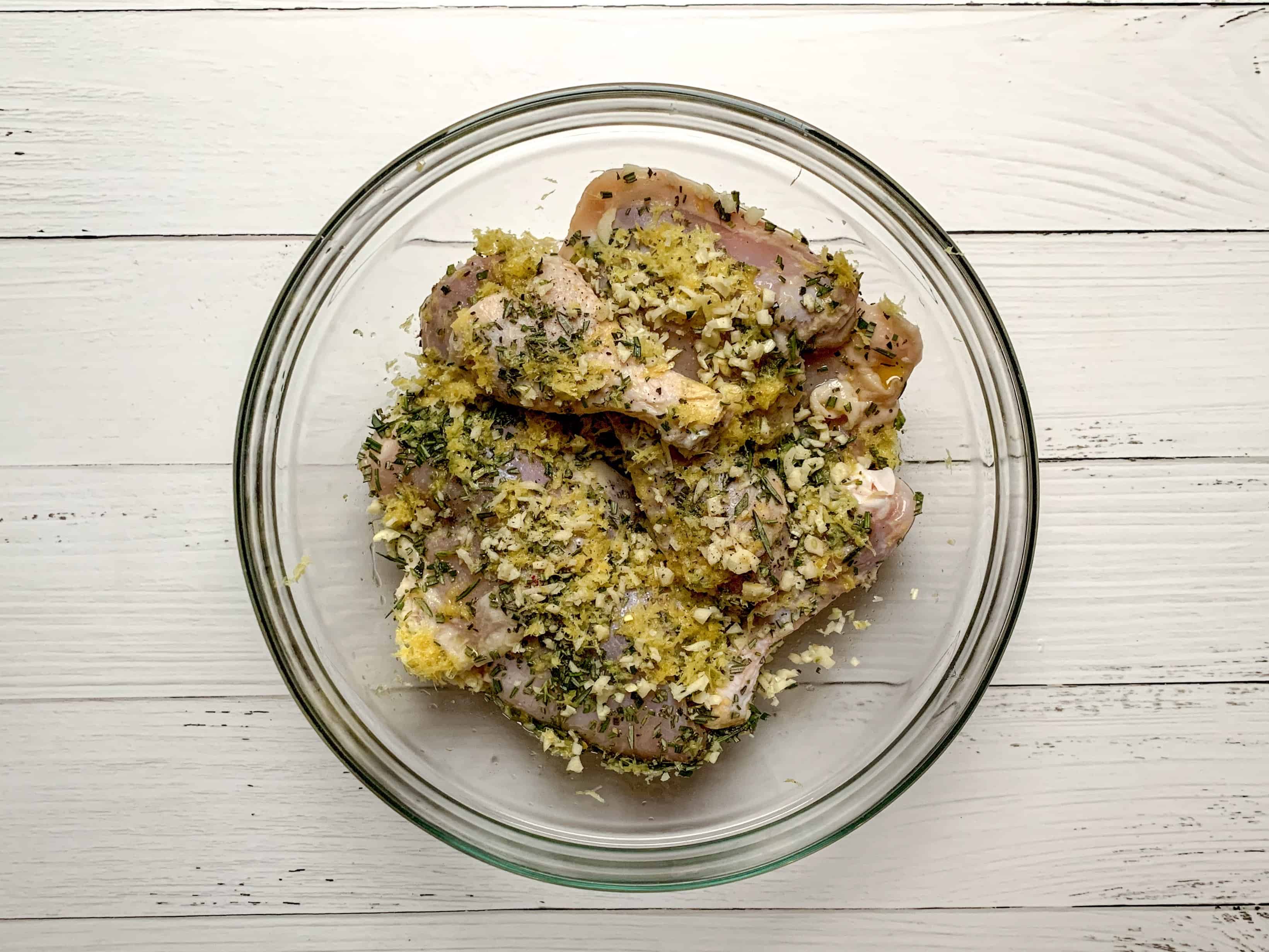 bowl full of chicken, rosemary, and lemon zest