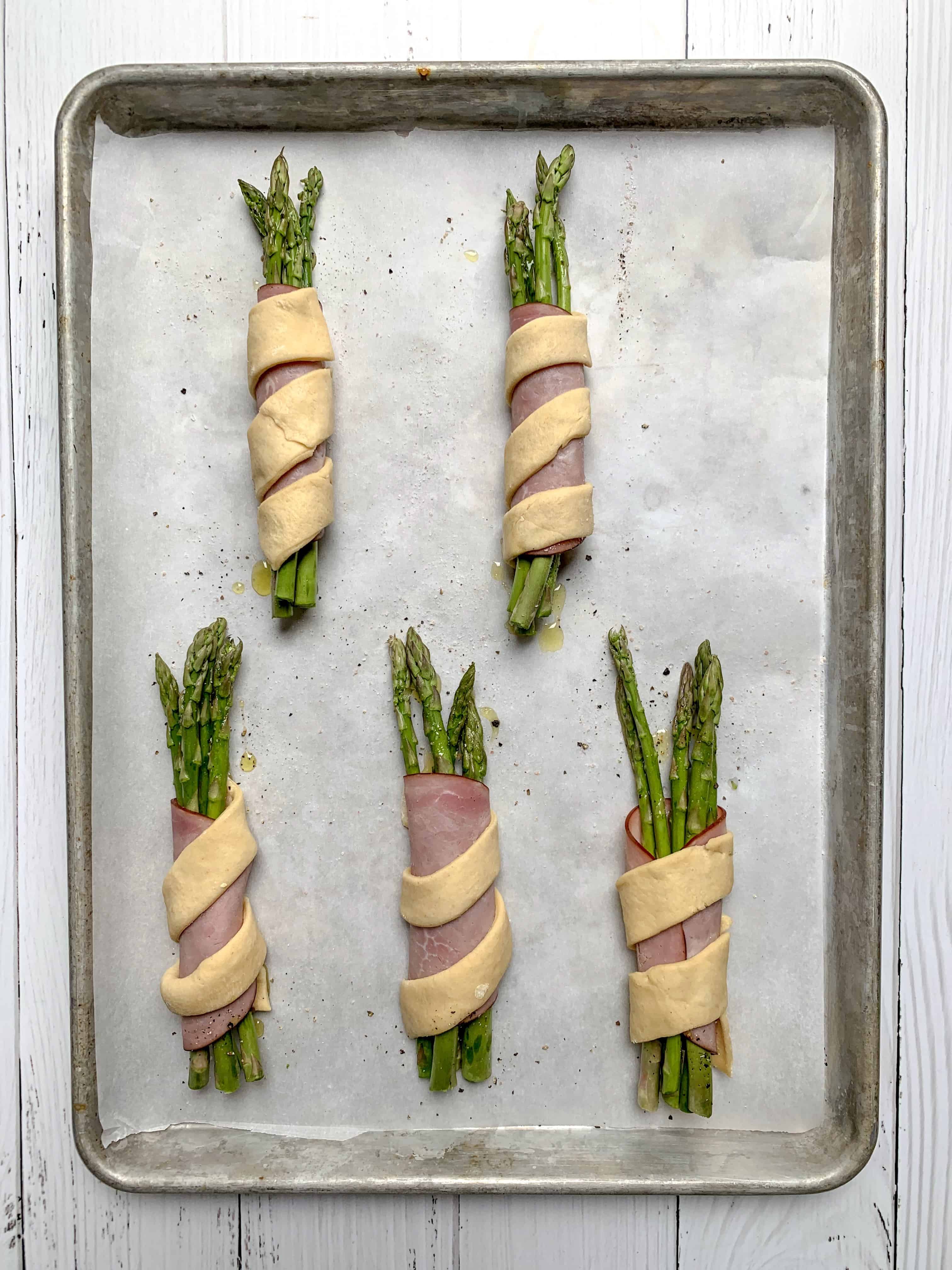 aerial view of the bundles of wrapped asparagus before being baked. 