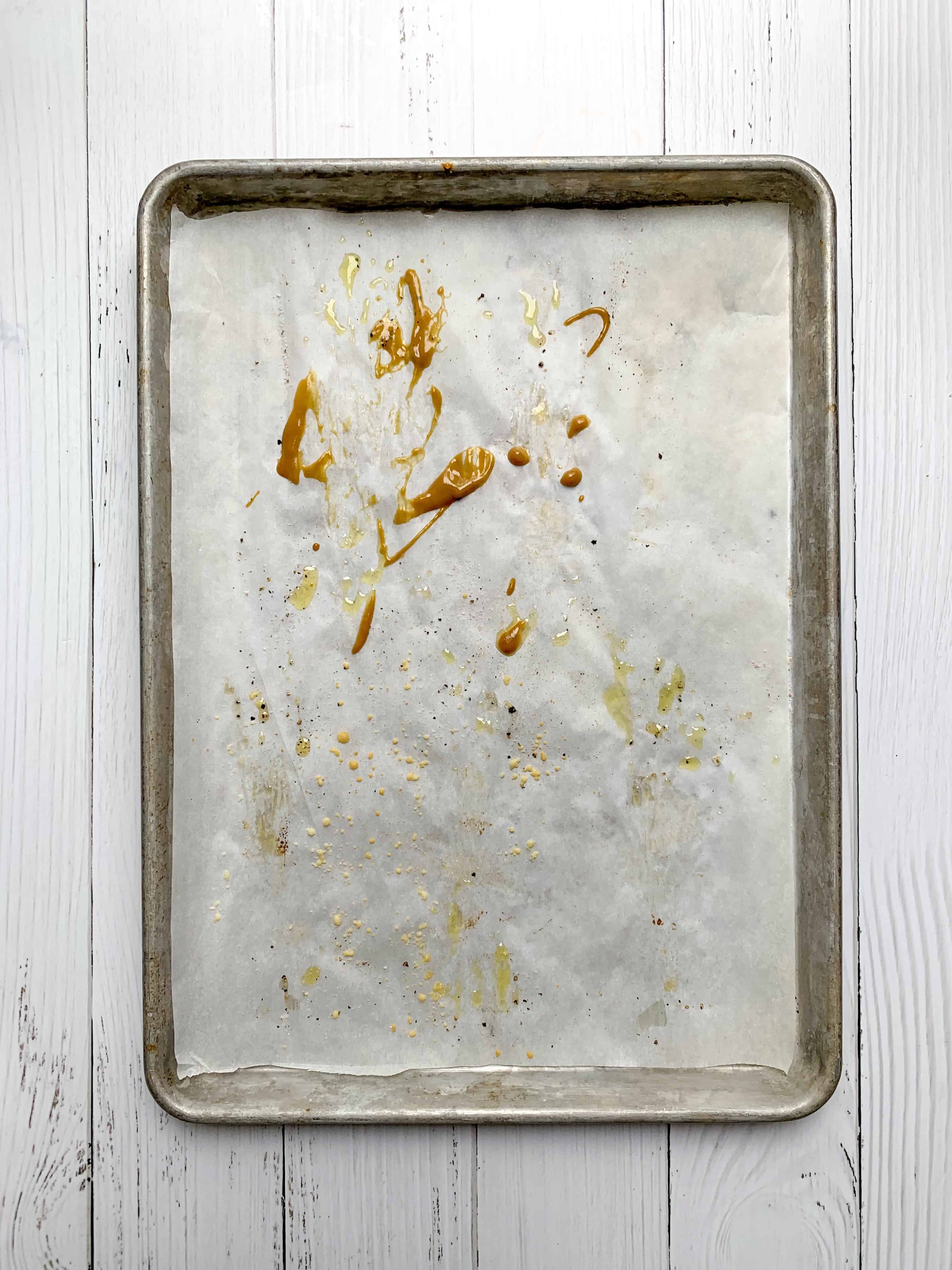 empty baking tray with only a little bit of honey mustard splatters