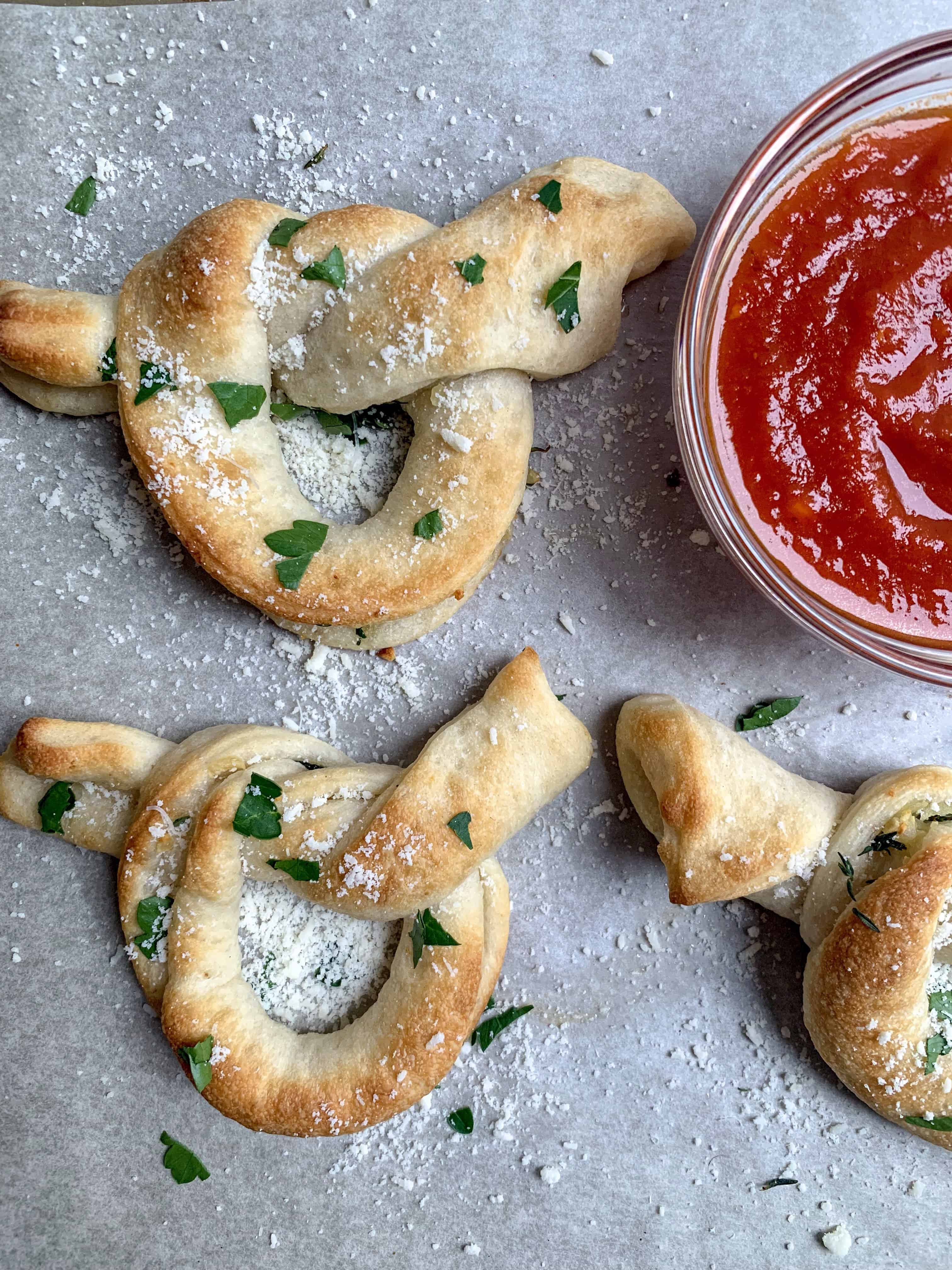 aerial picture of 3 garlic knots with fresh parsley