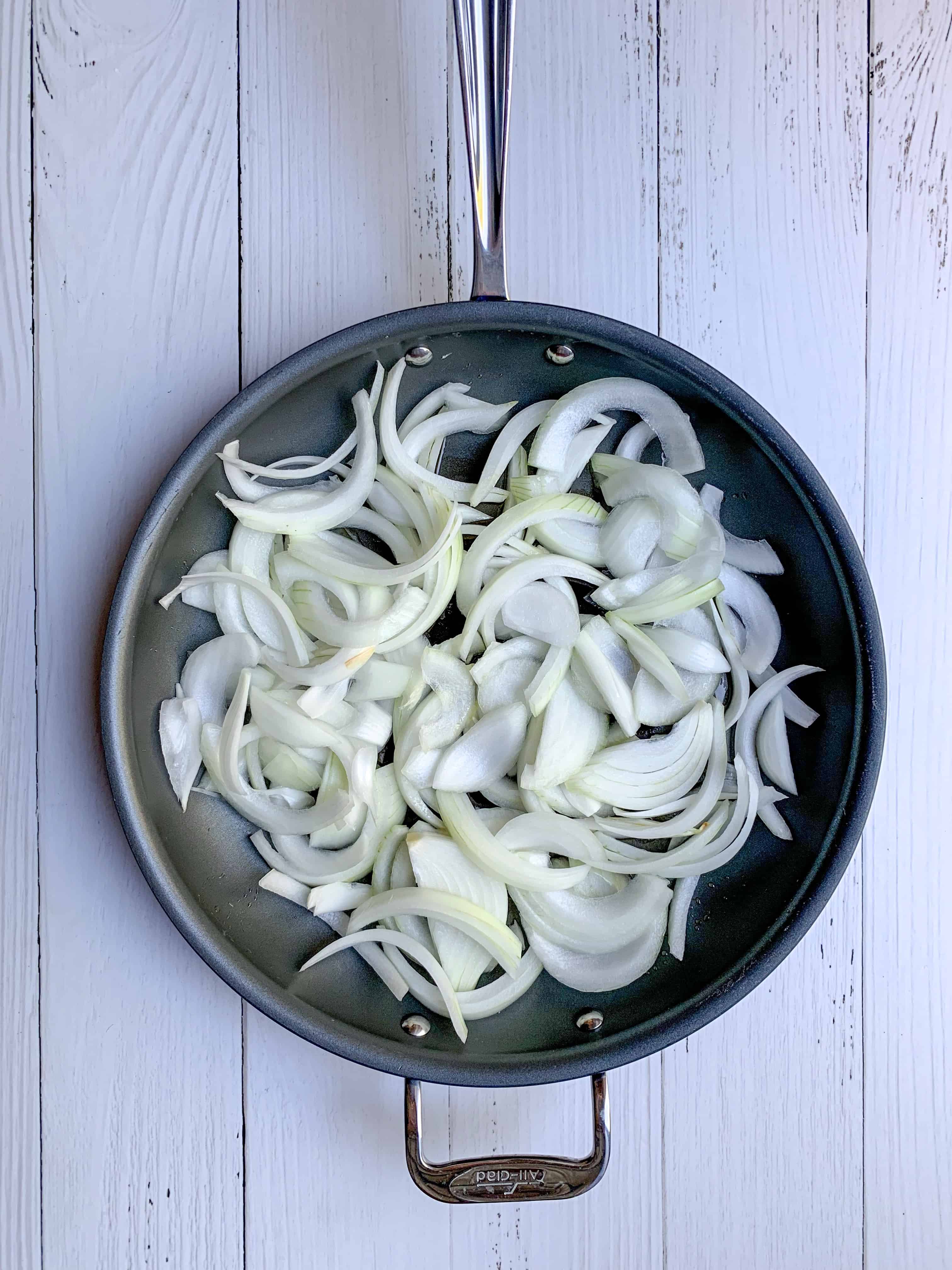 gallery picture of onions cooking in pan. 