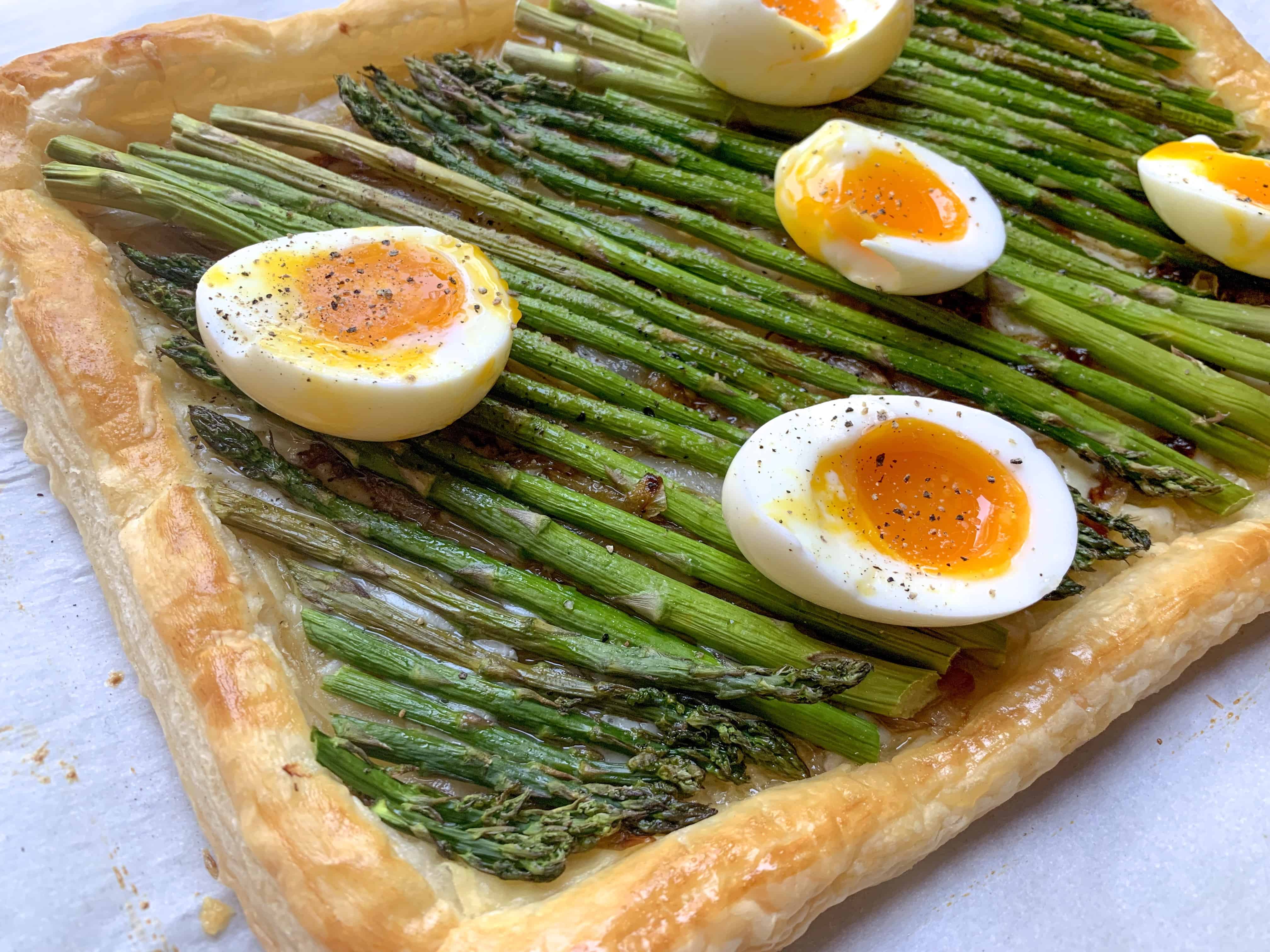 close up of asparagus tart with jammy eggs.