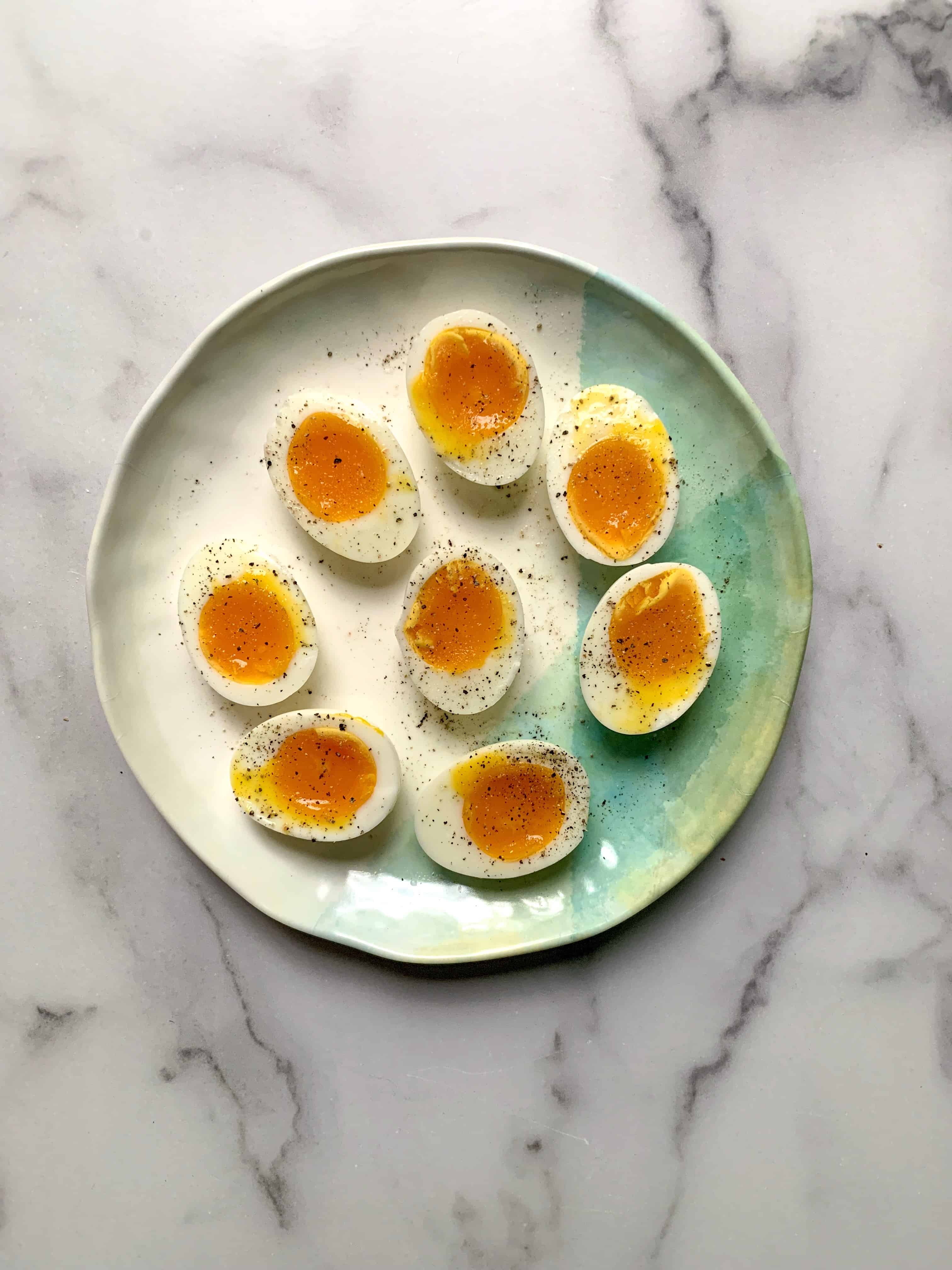 plate of cut jammy eggs so you can see the yolks.