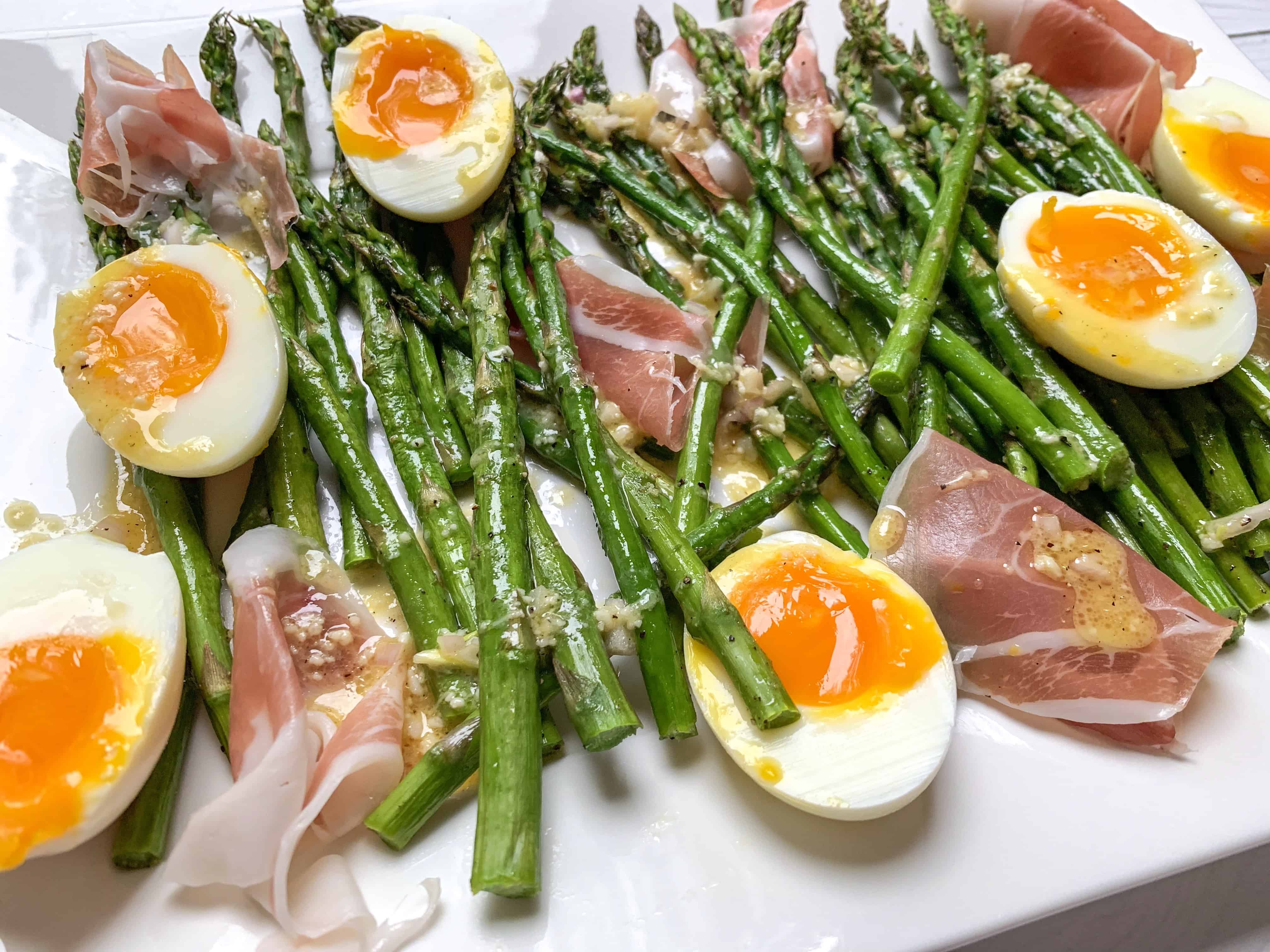 close up picture of asparagus and jammy eggs. 