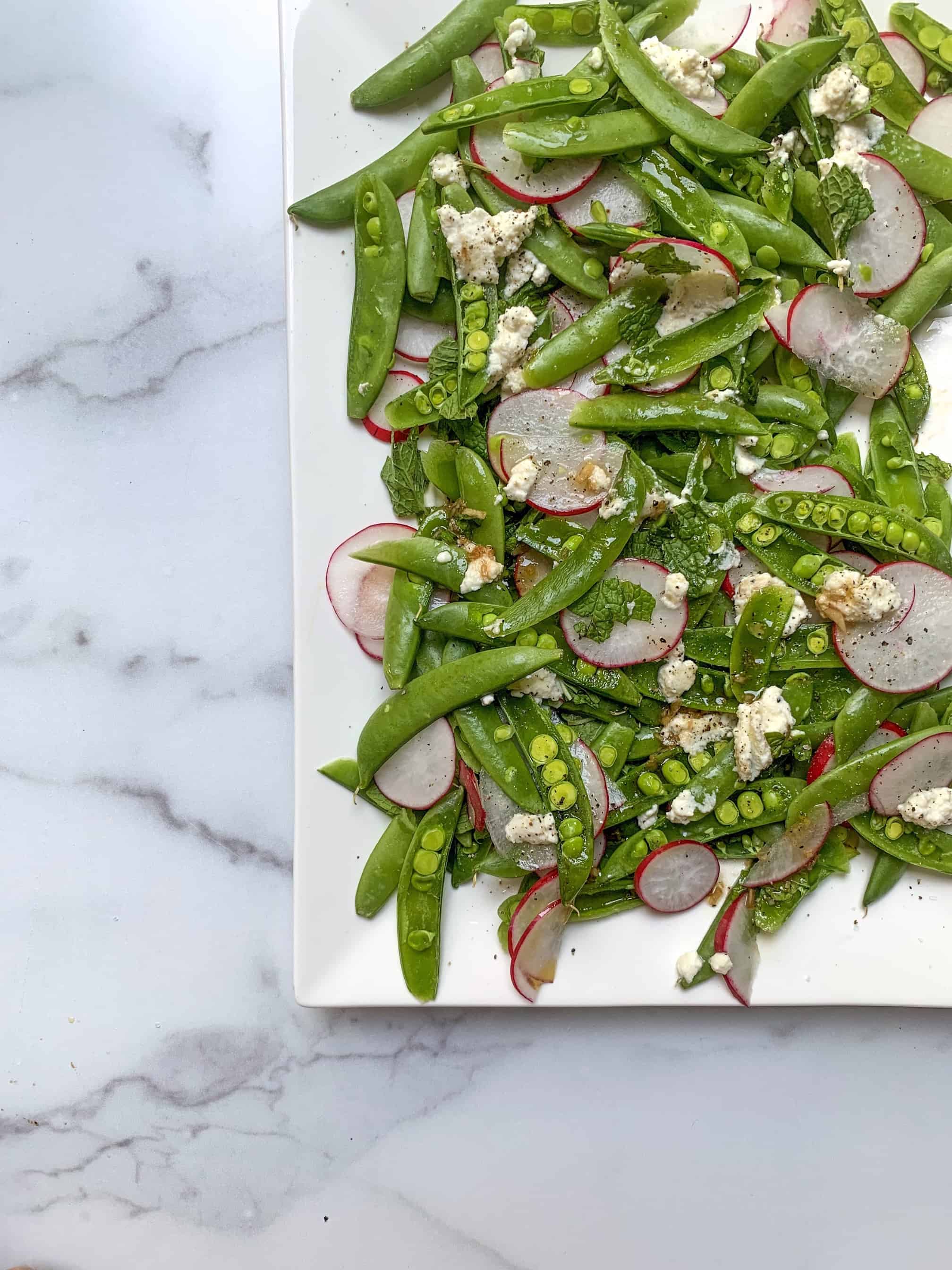 aerial view of sugar snap pea salad tossed in lemon balsamic vinaigrette 