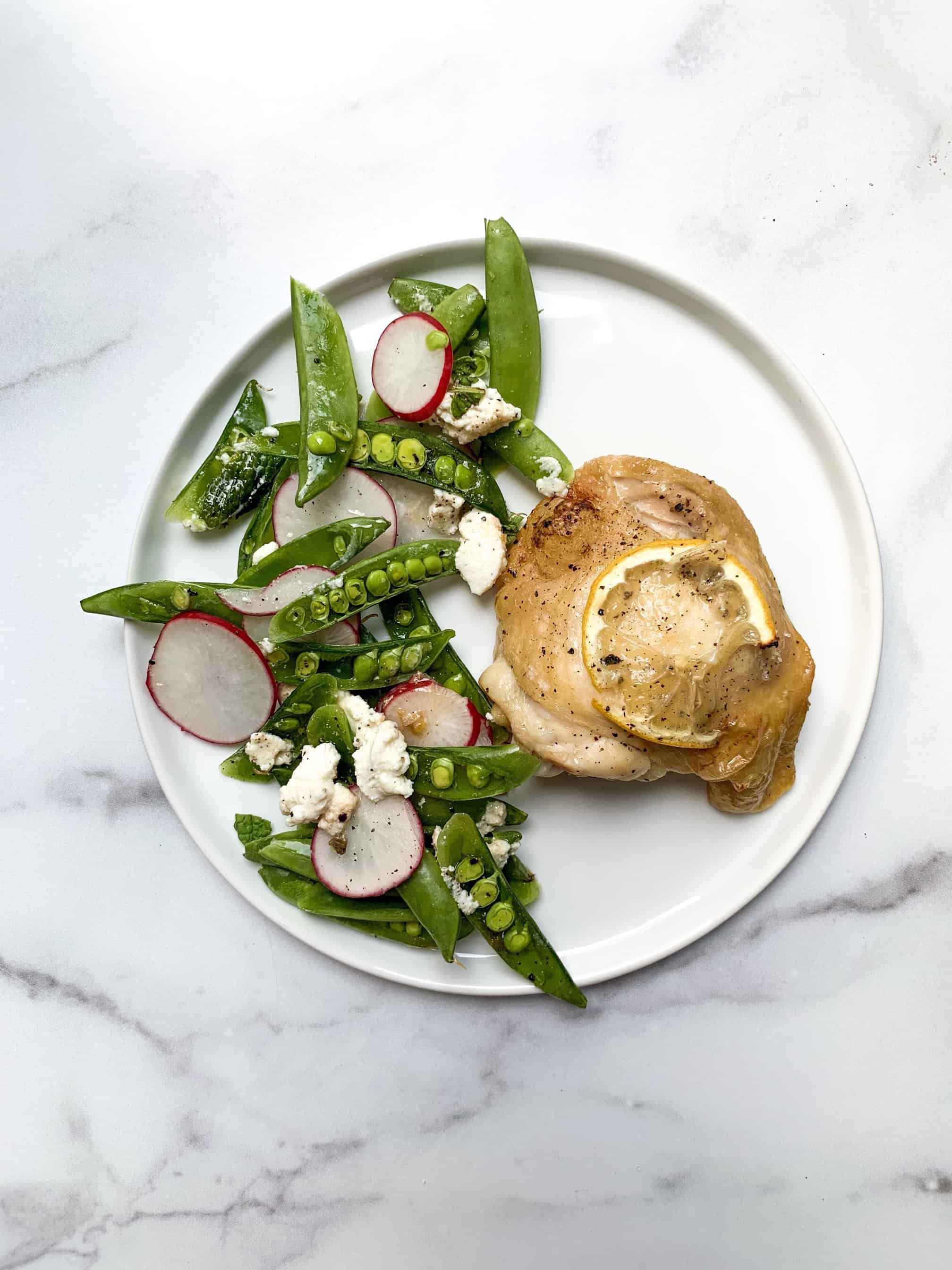 roasted chicken thigh with salad on white plate