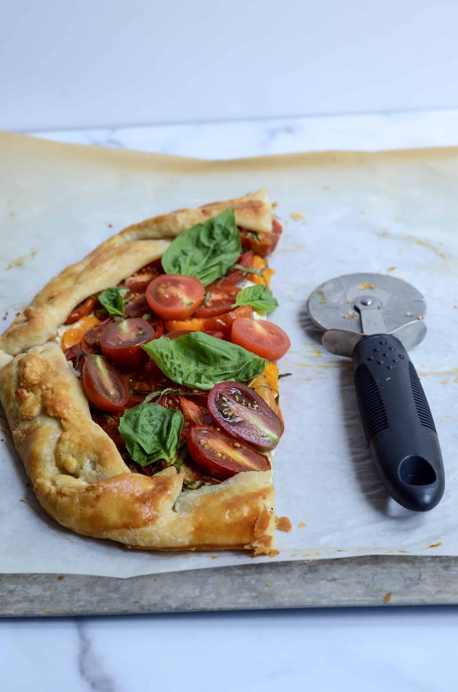 half eaten tomato and goat cheese galette