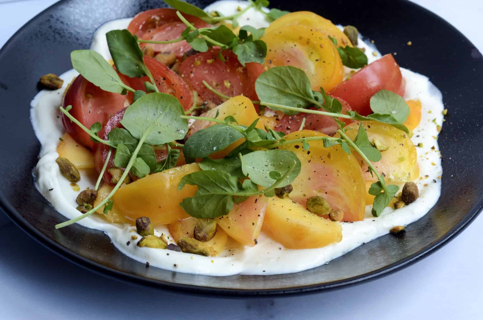 tomato and peach salad with whipped goat cheese