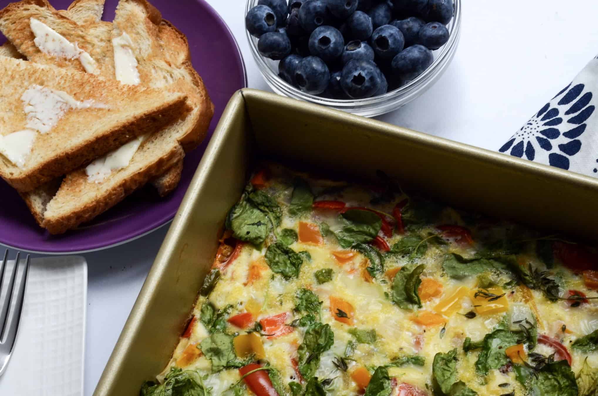 egg and vegetable breakfast bake with toast and blueberries