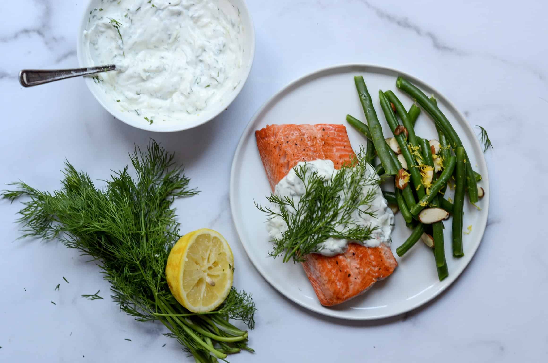 plate of salmon with dill tzatziki and green beans