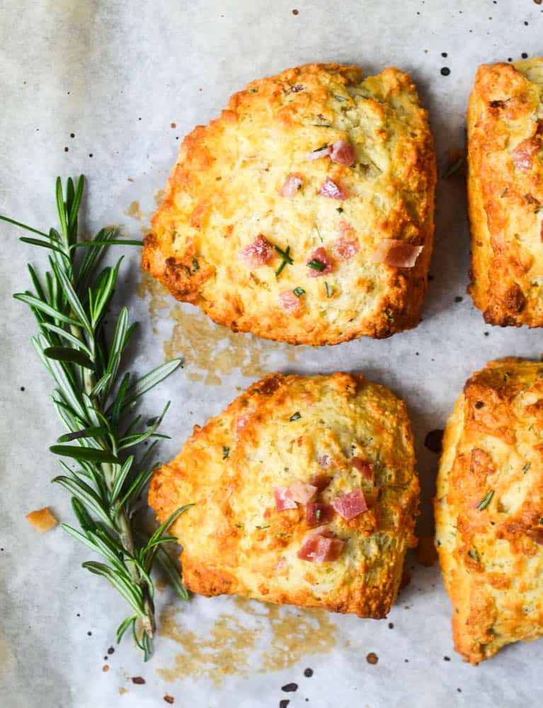 close up of rosemary and bacon biscuits with rosemary sprig