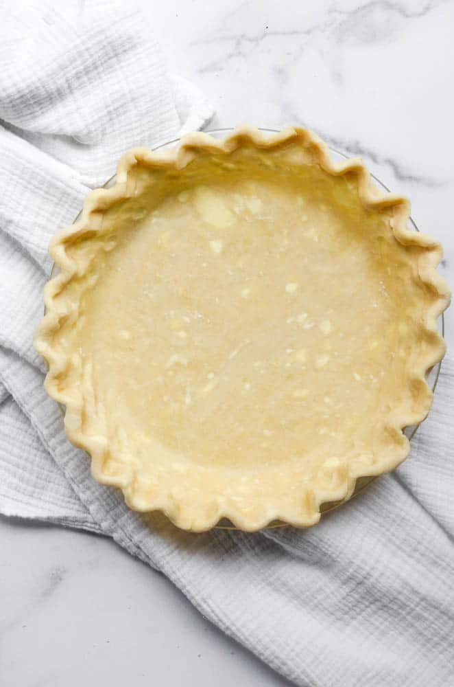 pie crust with crimped edges on top of white napkin