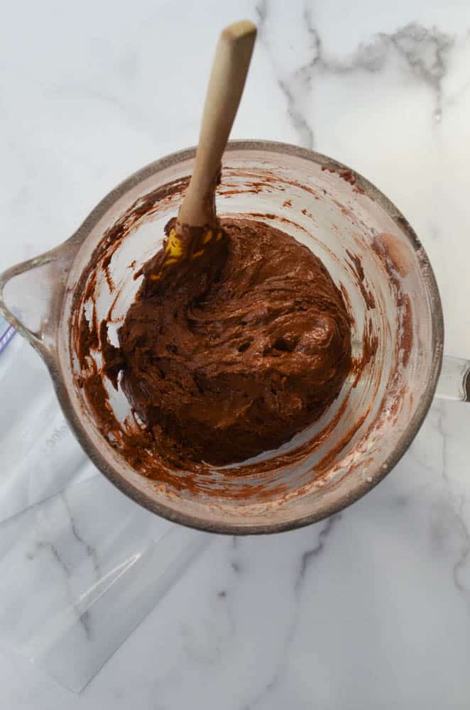 bowl with chocolate donut batter ready to be put in plastic bag