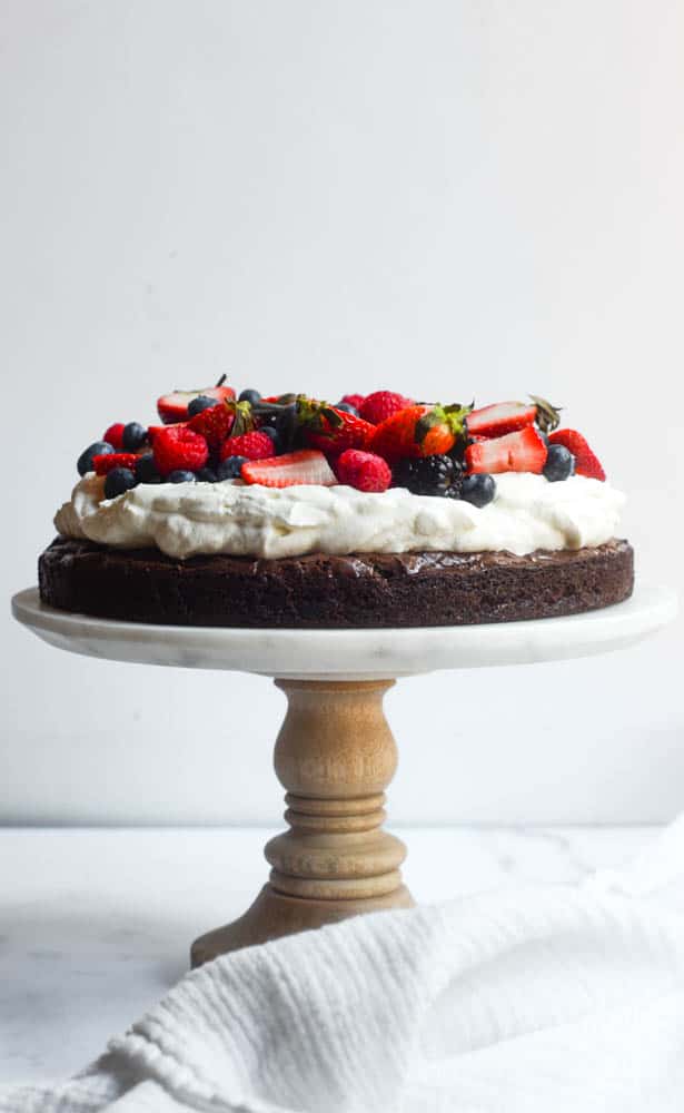 side view of brownie pizza cake on cake plate