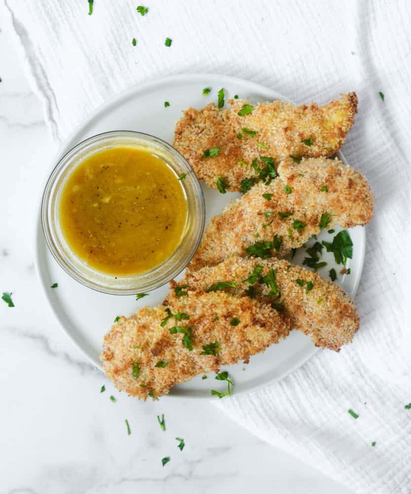 aerial view of chicken fingers with bowl of honey mustard sauce