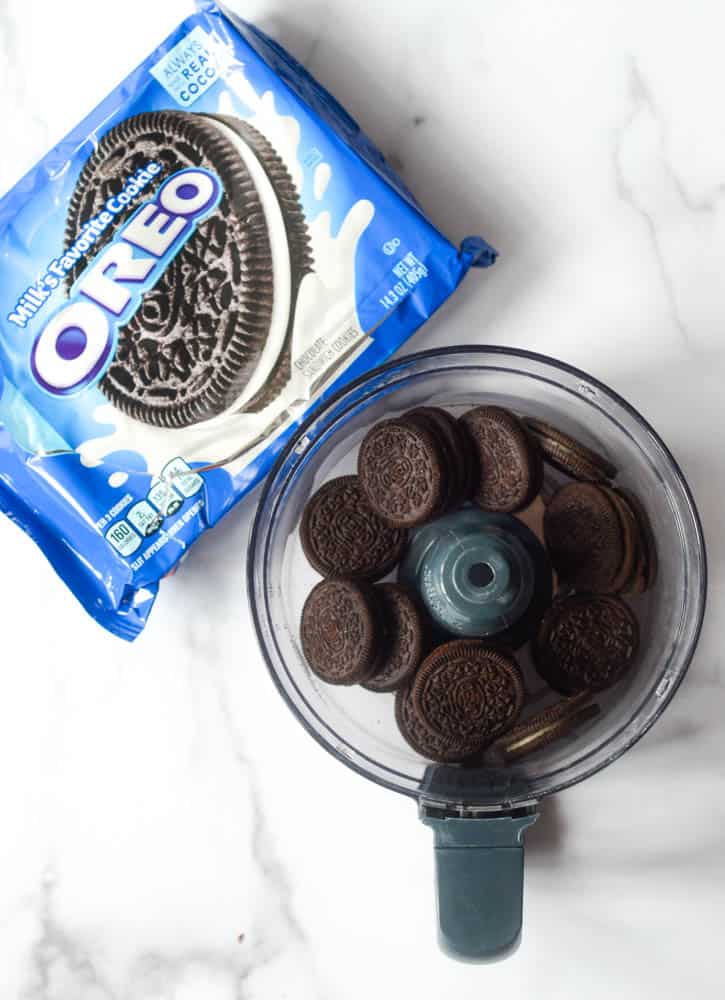 food processor bowl with Oreos in it next to package of Oreos.