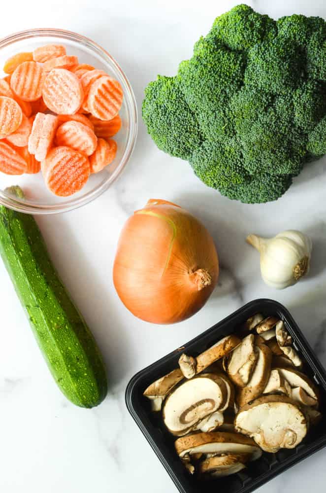 aerial shot of zucchini, mushrooms, onion, garlic, broccoli, and carrots