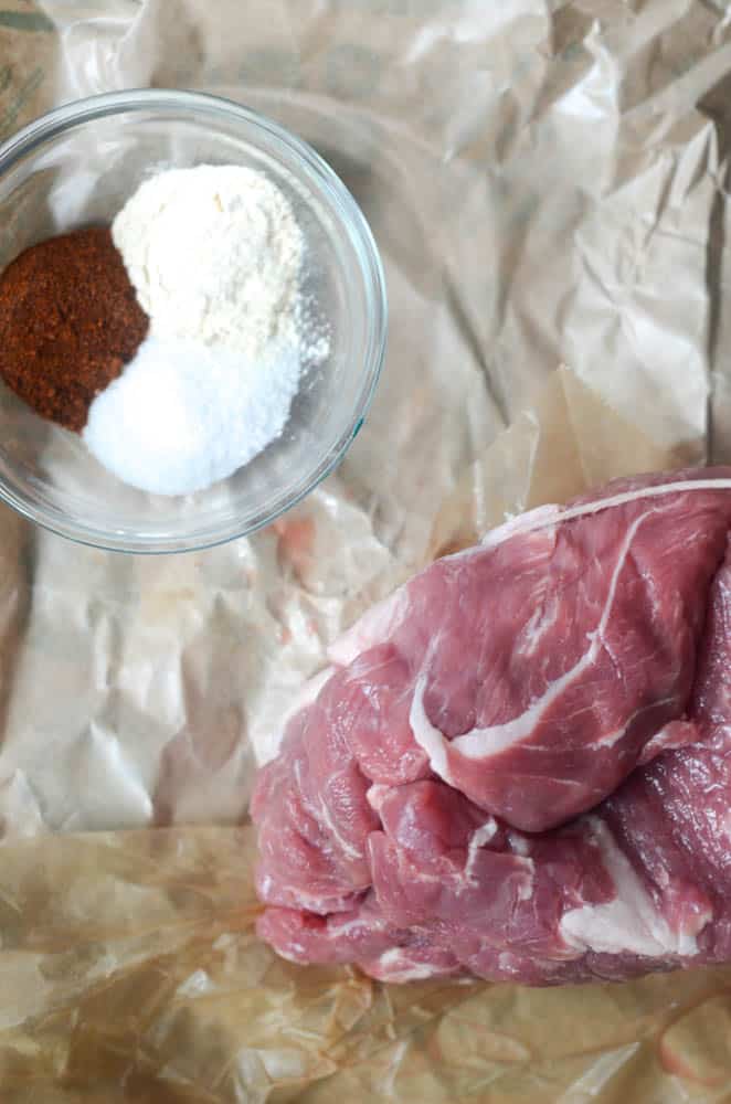 cut of pork shoulder on butcher paper to be used for dutch oven pulled pork