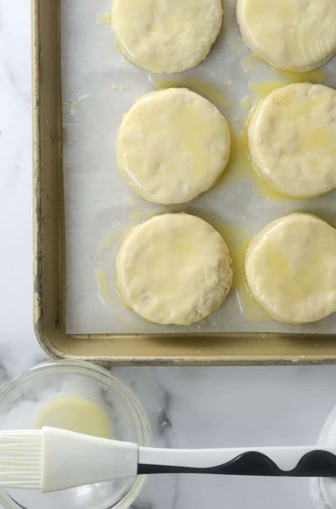 aerial shot of cut biscuit dough covered with butter on top