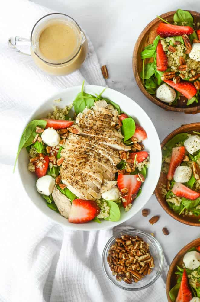 aerial shot of bowl of strawberry caprese salad with grilled chicken breast on top