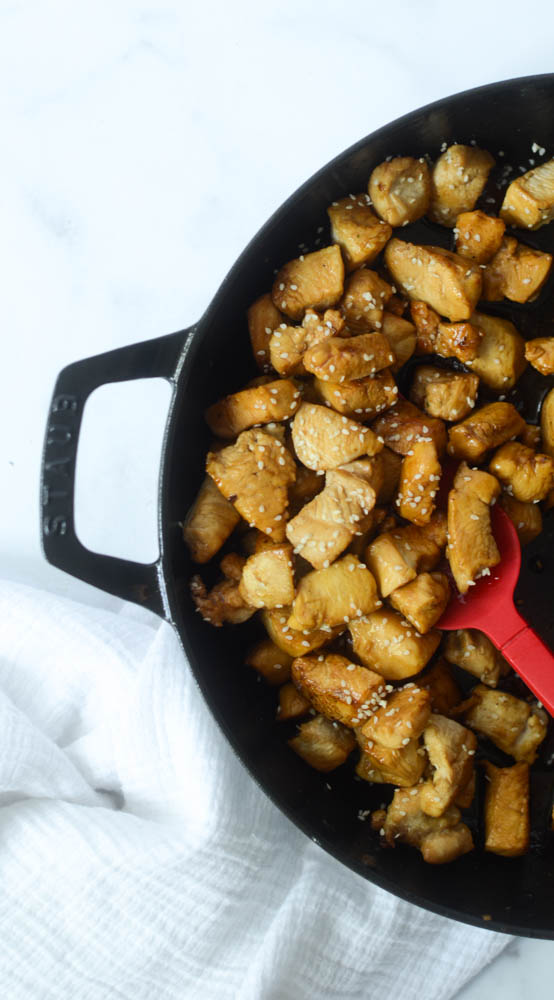 flat lay of large non-stick skillet with hibachi chicken with red spatula in chicken