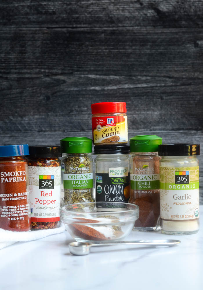 head on picture of 7 jars of spices you need to make your homemade taco seasoning 