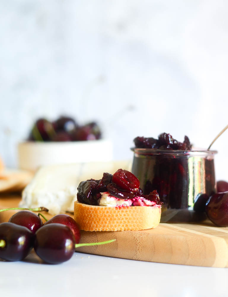 cherry compote, cherries, and baguette with cheese nad cherry compote on top. 