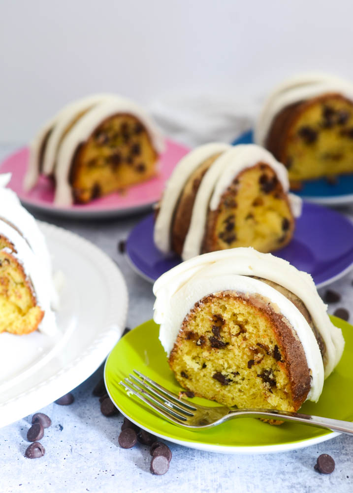 four slices of cake on brightly colored plates.