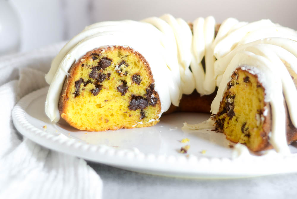 side shot of bundt cake sliced open to reveal chocolate chips inside