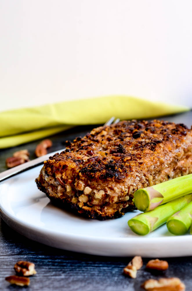 up close picture of fish filet on white plate with asparagus