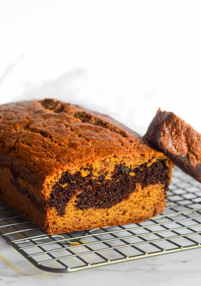 side view of pumpkin chocolate bread on wire rack. 