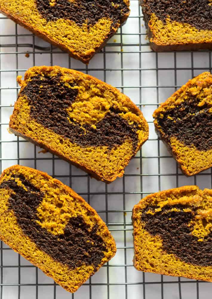 aerial picture of slices of pumpkin bread laying on wire rack. 