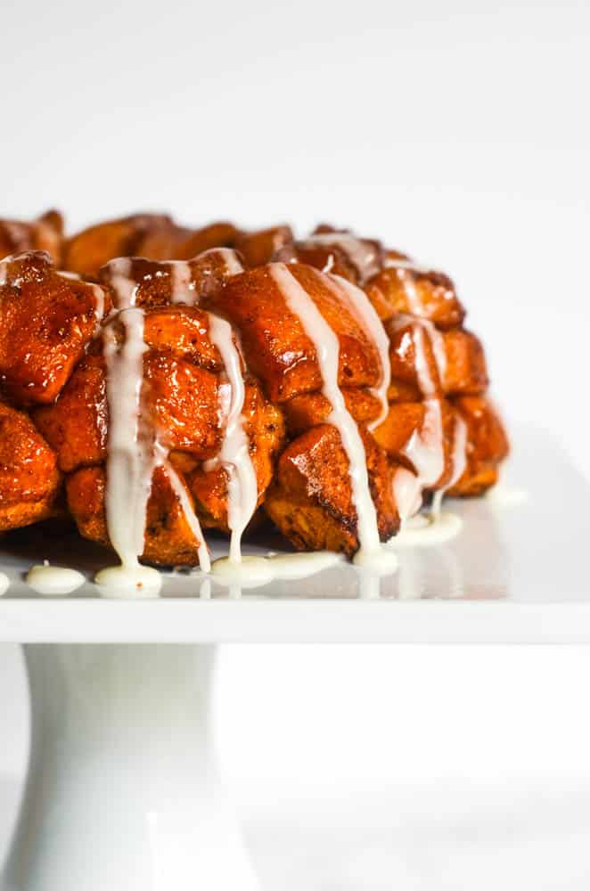 up close side picture of monkey bread drizzled with icing. 