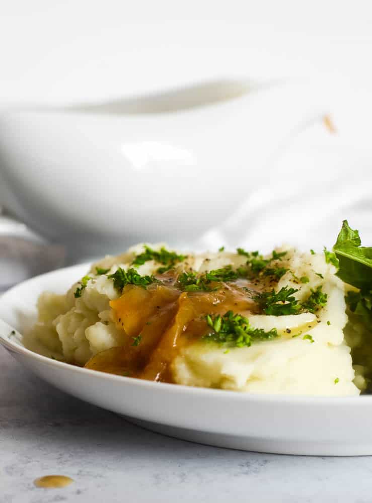 mashed potatoes with onion gravy on top along with generous amount of parsley. 