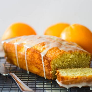 orange pound cake with first slice cut on wire rack