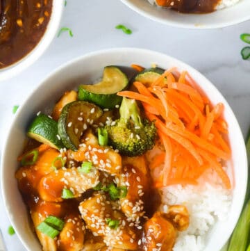 chicken teriyaki bowl over white rice with vegetables.