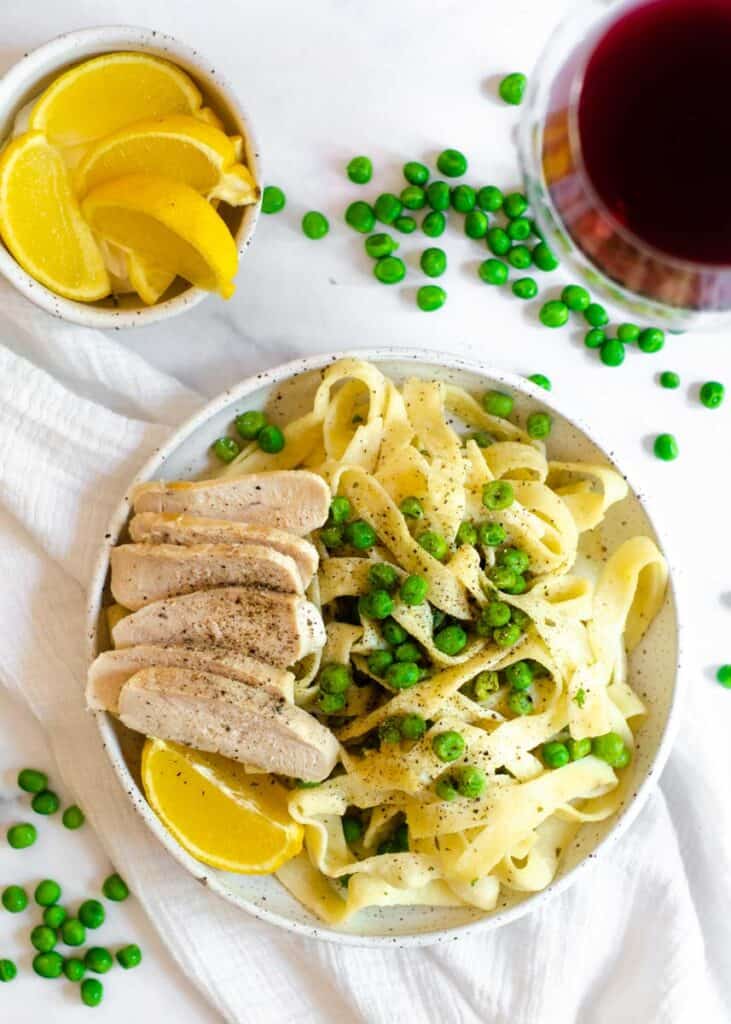 aerial photo of Boursin pasta with strips of cooked chicken breast on the side. 