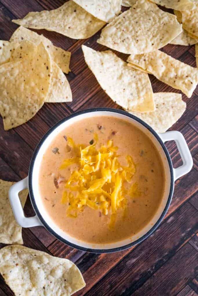 cheese dip in small white pot garnished with extra cheese.
