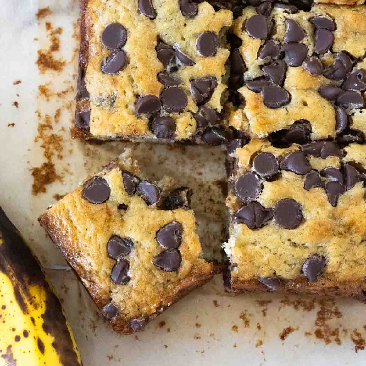 Corner piece of the banana cake with plenty of chocolate chips on top. 