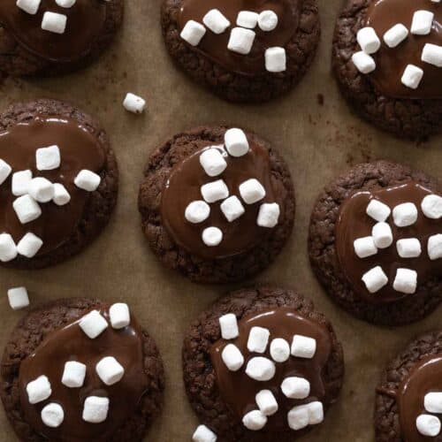 Hot cocoa cookies nestled together on a baking sheet.