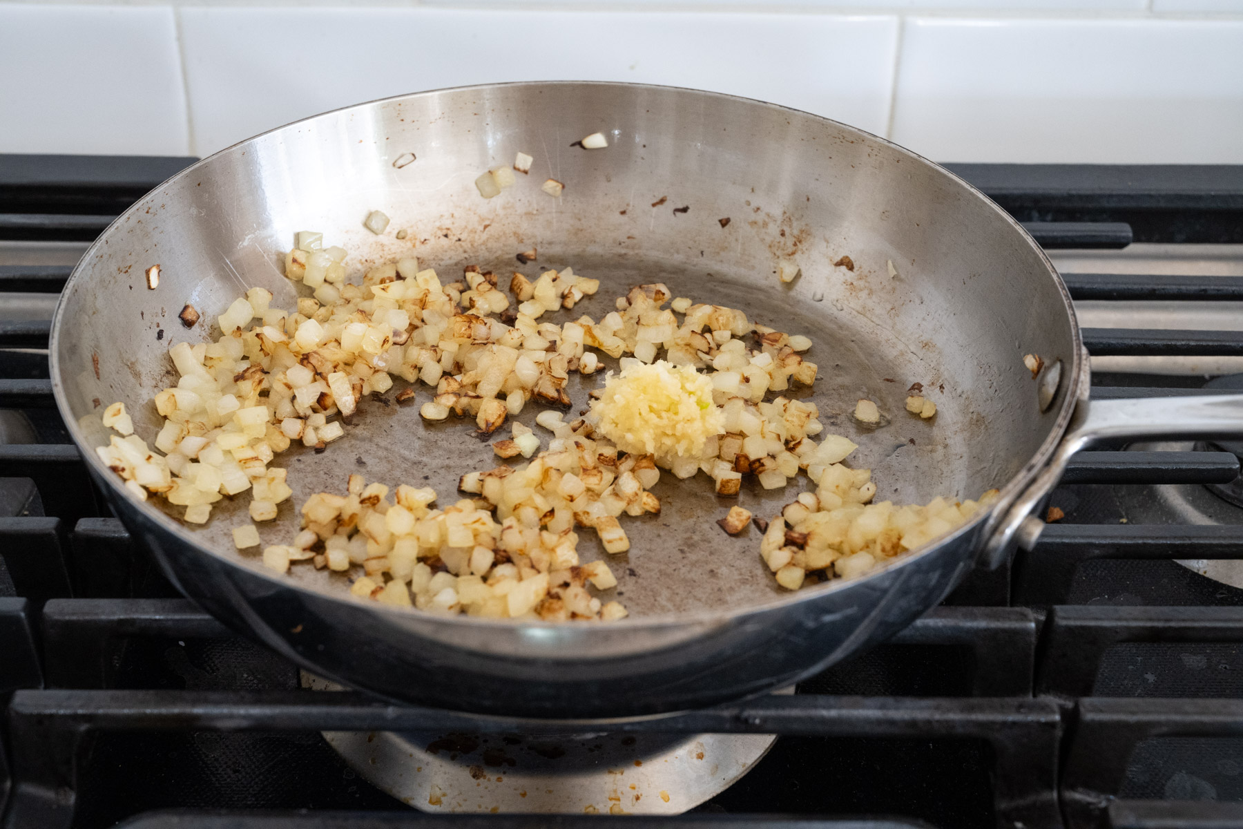 Step 3 of the directions showing garlic being added to the tender onions. 