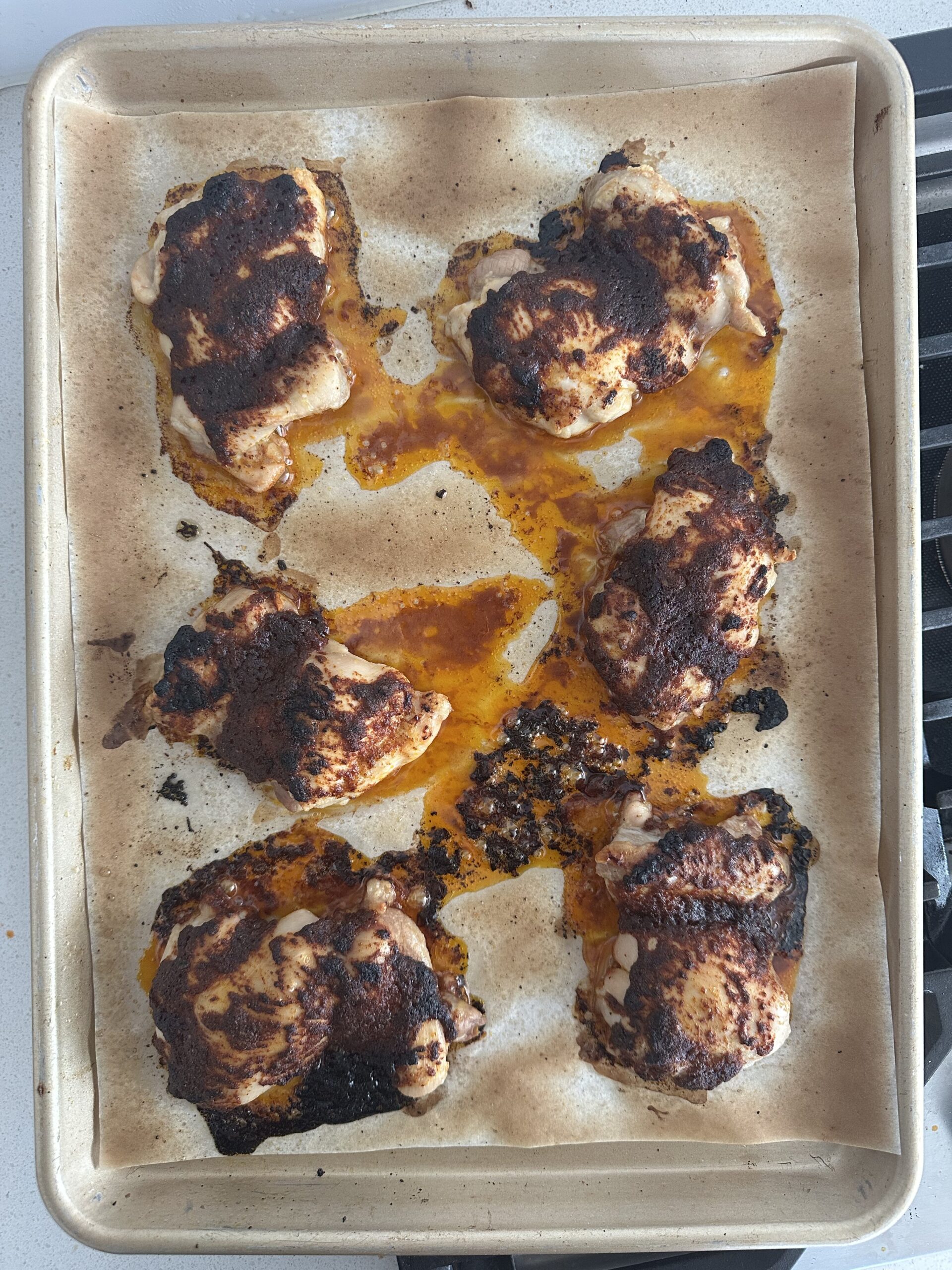 Sheet pan of baked and broiled chicken thighs